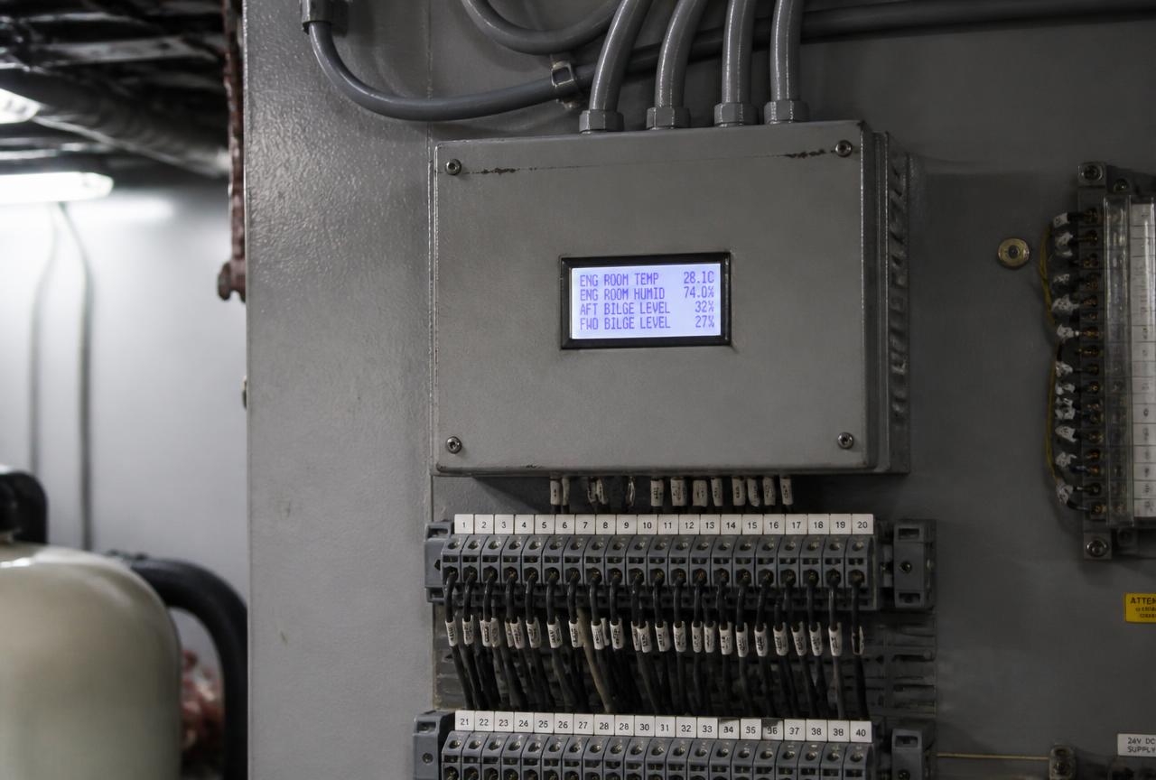 Engine room alarm monitoring enclosure with digital readout and numbered terminal blocks aboard a yacht