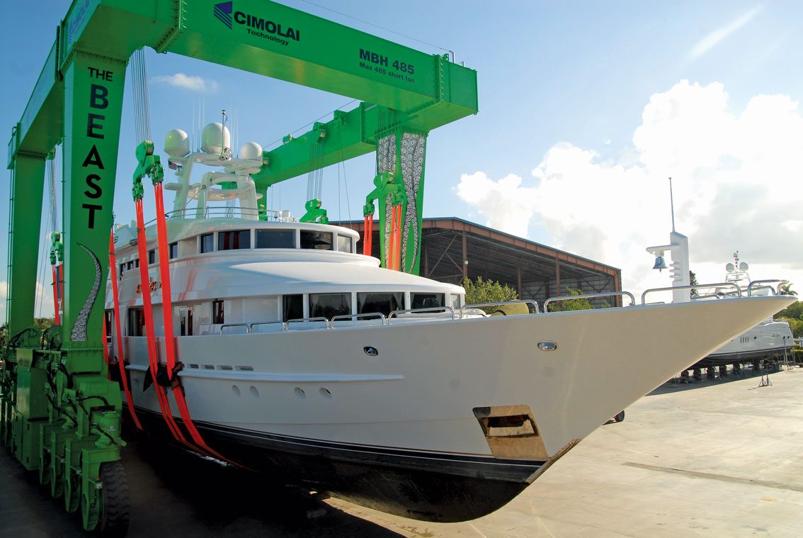 Superyacht lifted in a travel lift on haul-out at a South Florida shipyard for class survey work